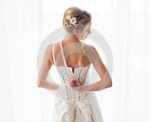 Bride unzipping her dress