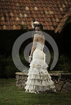 Bride in vintage dress looking back over her shoulder