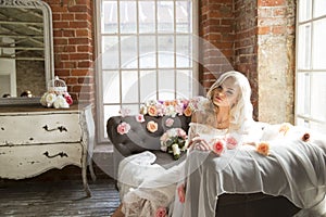 Bride on vintage sofa with flowers