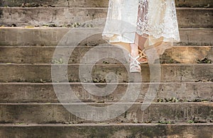 Bride walking down stairs in wedding dress