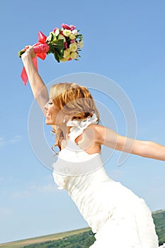 Bride waving colorful posy