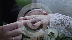 Bride wear ring on groom`s finger. The groom puts the wedding ring to finger of the bride. marriage hands with rings
