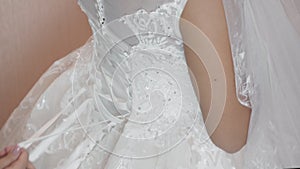 The bride is wearing a beautiful wedding dress closeup