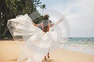 Bride wearing beautiful wedding dress on the tropical beach