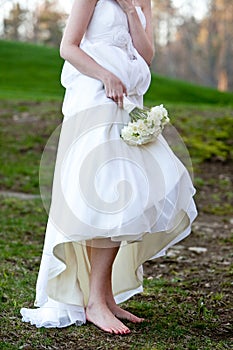 Bride wearing no shoes in the mud
