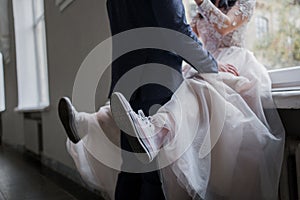 Bride wearing a wedding dress and sneakers