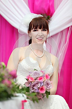 Bride wearing white dress holds bouquet