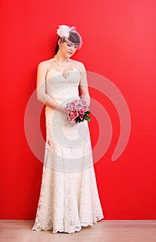 Bride wearing white dress holds bouquet