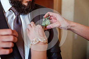 The bride wears a groom boutonniere