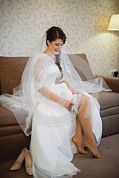 The bride wears a wedding garter on leg
