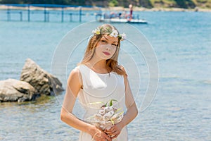 Bride with wedding crown and bouquet of seashels