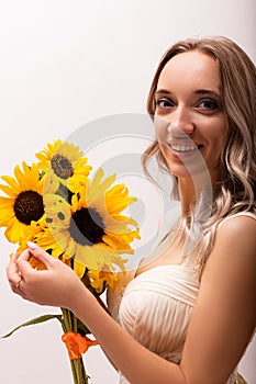 Bride in a wedding dress with a bouquet of sunflowers.Beautiful woman.Floristics