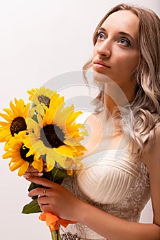 Bride in a wedding dress with a bouquet of sunflowers.Beautiful woman.Floristics