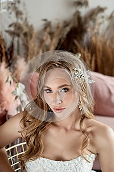 Bride in wedding dress. Young fashion model with perfect skin, make up and Beautiful Hairstyle. Happy day. Marriage.