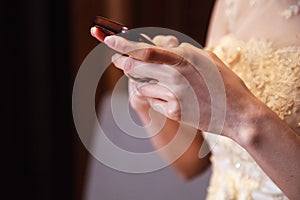 Bride in wedding gown using smart mobile phone, Shopping and Communicating with digital technology. Modern Trend, Lifestyle,