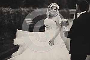 Bride whirls standing behind a groom