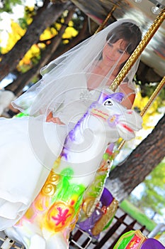 Bride on a white carousel horse