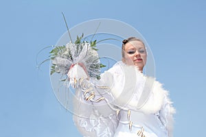 Bride in white dress again blue sky