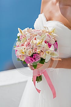 Bride in white dress with bouquet of flowers