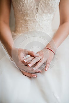 The bride in a white dress excitedly twirls her ring