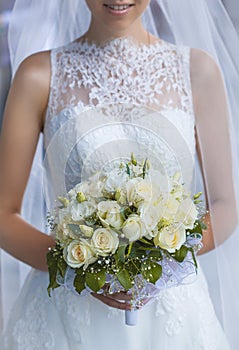 Bride in White Dress Holding Splendid Bridal Boquet