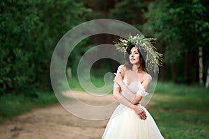 Bride in a white dress with a wreath of flowers