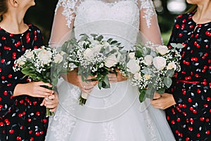 bride in a white lace dress and two girls