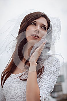 Bride in white veil and dress. Wedding photo.