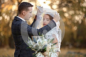 bride in white wedding dress and groom outdoor