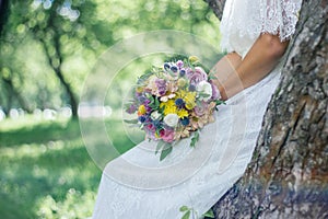 Bride in white wedding dress holding wedding bouquet.