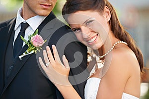 Bride woman, hug groom and portrait with smile, diamond ring and excited with love, care and fresh start. Couple