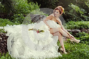 bride woman with long legs in lush wedding dress.