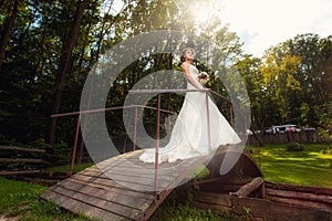 Bride on wooden bridge in the forest