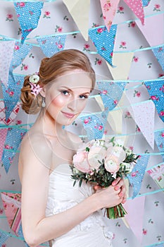 Bride.Young fashion model with make up, ,curly hair, flowers in hair. Bride fashion. Jewelry and Beauty. Woman in white dress