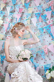 Bride.Young fashion model with make up, ,curly hair, flowers in hair. Bride fashion. Jewelry and Beauty. Woman in white dress