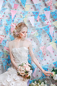 Bride.Young fashion model with make up, ,curly hair, flowers in hair. Bride fashion. Jewelry and Beauty. Woman in white dress