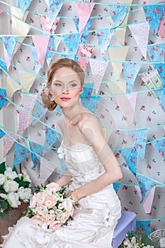 Bride.Young fashion model with make up, ,curly hair, flowers in hair. Bride fashion. Jewelry and Beauty. Woman in white dress