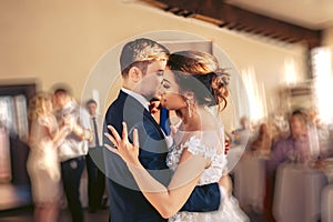 The bridegroom embraces the bride during the wedding dance