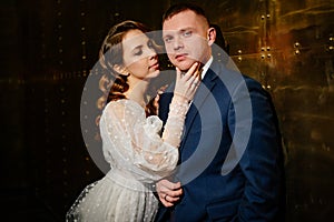 bridegroom and bride in a elegant dress in a dark corridor
