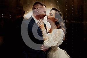 bridegroom and bride in a elegant dress in a dark corridor