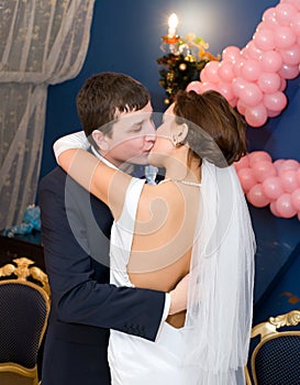 Bridegroom and bride kiss