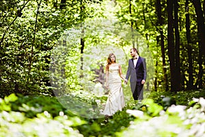 Bridegroom and bride in the spring forest