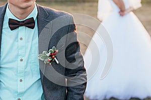 The bridegroom in the foreground, and the bride in the back.