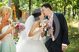 The brides kissing in the park