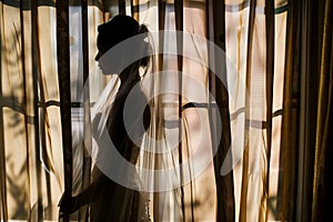 brides silhouette through sheer curtains