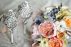 Brides wedding shoes with a bouquet with roses.