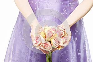 Bridesmaid holding bouquet of pink roses