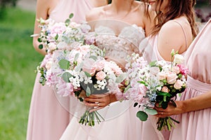 Bridesmaid`s bouquets, wedding bouquets closeup. Stylish summer wedding. Contemporary fashion wedding trends.