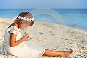 Bridesmaid Sitting On Beach At Wedding Ceremony