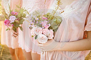 Bridesmaids in pink dresses with bouquets